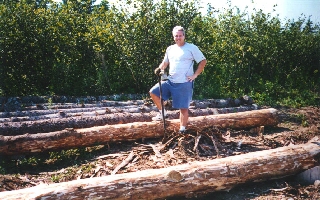 Glenn taking a break after peeling logs.
