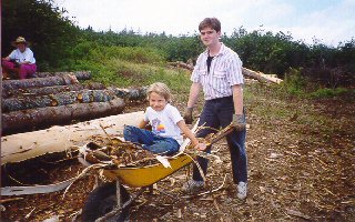 Liz & kids peeling logs
